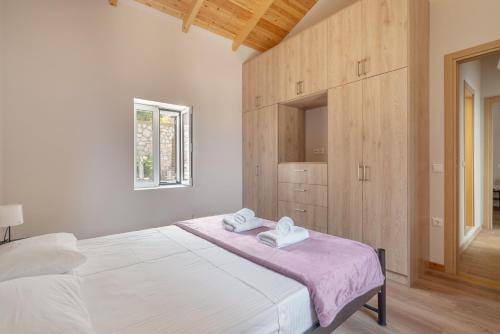 a bedroom with a bed with two towels on it at Ionian Home in Exanthia