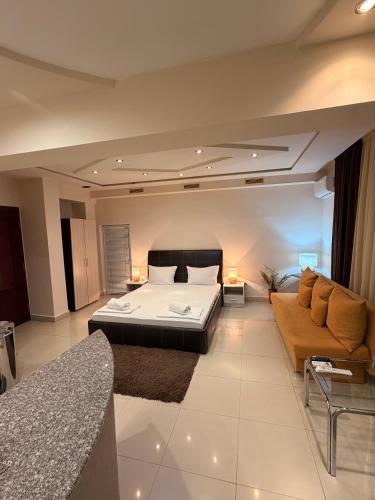 a large bedroom with a bed and a couch at Venis House in Plovdiv