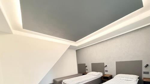 two beds in a room with a white ceiling at Domek 80m2 na wyłączność in Tczew