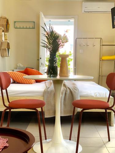 a room with a table and two chairs and a bed at Blue Loft 360 in Patra