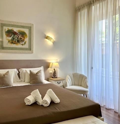 a bedroom with a large bed with two towels at Tre R Colosseo in Rome