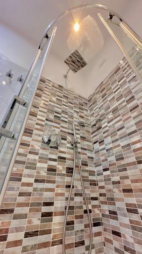a bathroom with a shower with a checkered floor at Tre R Colosseo in Rome
