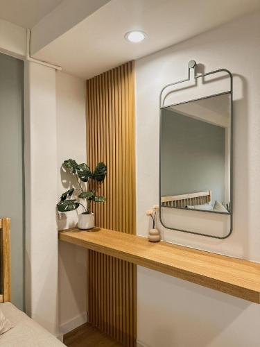 a mirror sitting on a shelf in a room at O2 Bangsaen in Ban Bang Saen (1)
