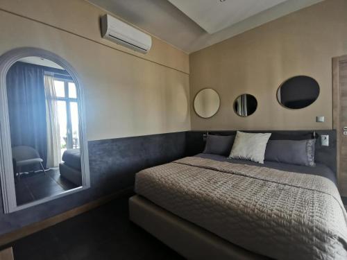 a bedroom with a bed and a large mirror at A Flor da Rosa in Vila Nova de Foz Coa