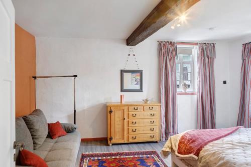 a bedroom with a bed and a wooden dresser at Zur Lupine in Bebra
