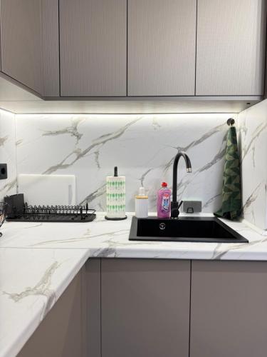 a kitchen with a sink and a counter top at Top Centre Apartment 5 mins to beach in Burgas