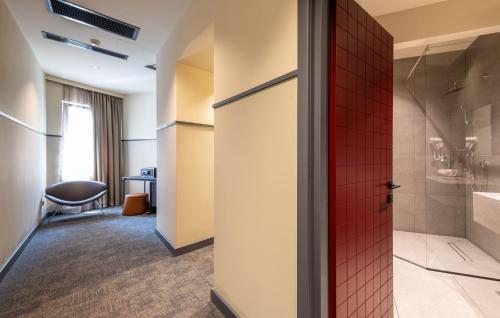 a bathroom with a shower and a red door at NOBO - Hotel in old Tbilisi in Tbilisi City