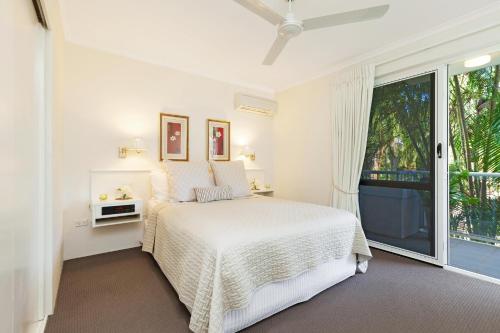 Un pat sau paturi într-o cameră la Paradise in the Tropics