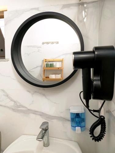 a mirror above a sink in a bathroom at TE Shkodrant 1 in Baks-Rrjoll