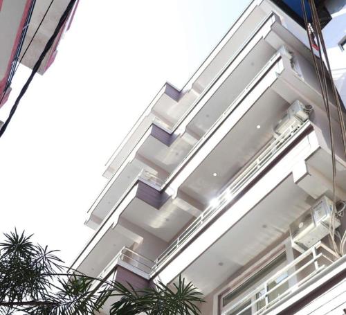 a white building with stairs on the side of it at Zouk Homes in Rishīkesh