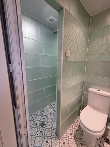 a bathroom with a toilet and a shower at Chez André in Cognac