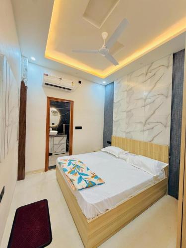 a bedroom with a large bed with a ceiling at Shri brijwasi palace in Vrindāvan