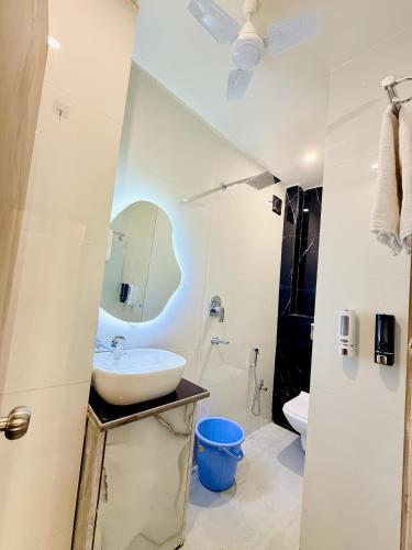 a white bathroom with a sink and a toilet at Shri brijwasi palace in Vrindāvan
