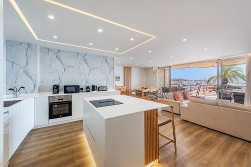 a kitchen and living room with a couch and a table at Apartment Vistamar III in Port de Pollensa