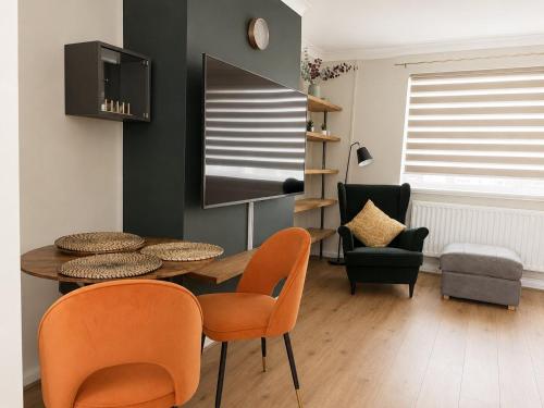 a dining room with a table and chairs at Llantarnam House by Tŷ SA in Cardiff