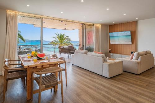 a living room with a table and a couch at Apartment Vistamar II in Port de Pollensa