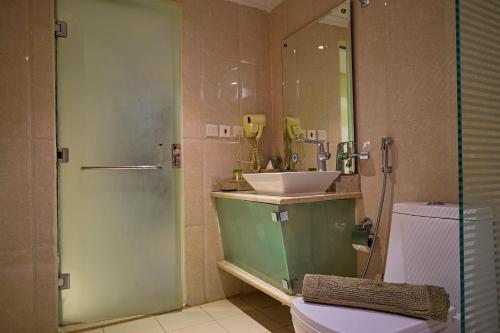 a bathroom with a sink and a toilet and a shower at Al Muhaidb Al Olaya Suites - Economic in Riyadh