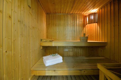 a wooden sauna with a towel on a bench at Airotel Achaia Beach in Patra