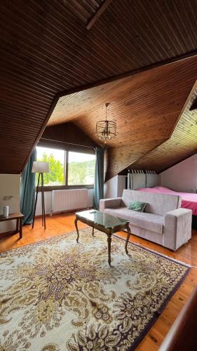 a living room with a couch and a table at Azure Escape Villa in Platamonas