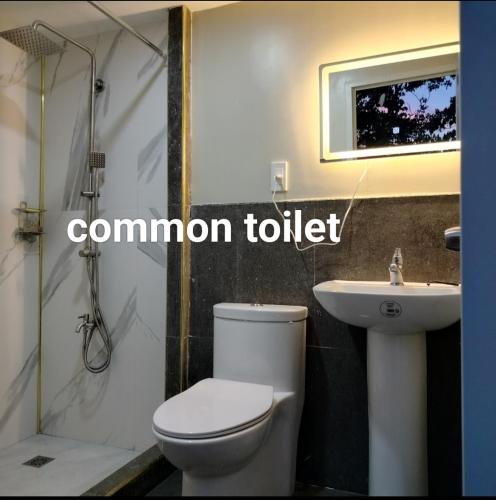 a bathroom with a toilet and a sink at Gerry's Place in Iloilo City
