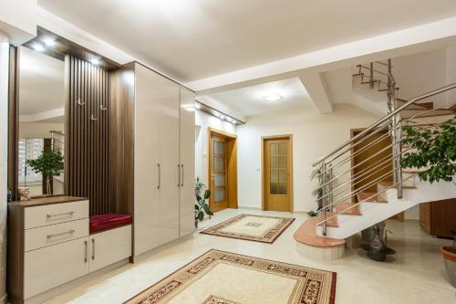 a living room with a staircase and a stair case at Apartments Nuhi in Ulcinj