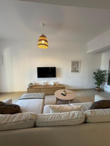 a living room with a couch and a table at Patmian charm 2 bedrooms in Skala