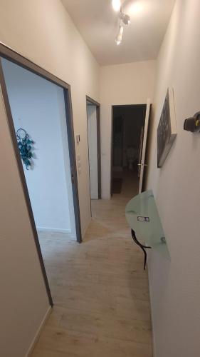 a room with a hallway with a door and a table at Gîtes & Chambres d'hôtes Villa La Lorraine in Folkling