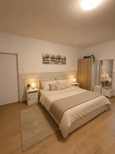 a bedroom with a large bed with two night stands and two lamps at 7Csakra Vendeghaz in Szentendre