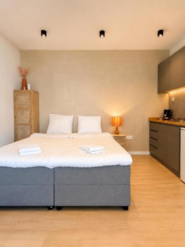 a bedroom with a large bed in a room at Luxury Lake Cabin in Alphen