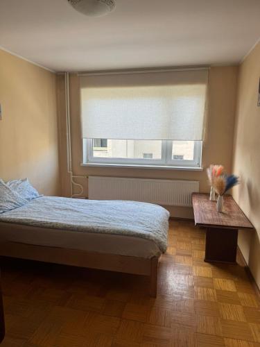 a bedroom with a bed and a window and a table at Joy Haven in Tallinn