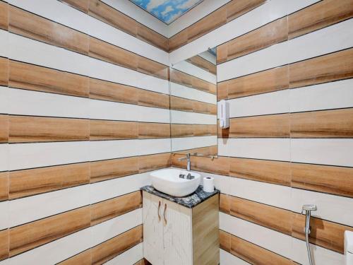 a bathroom with wooden walls and a sink at Hotel Paradise Palace in Ghaziabad