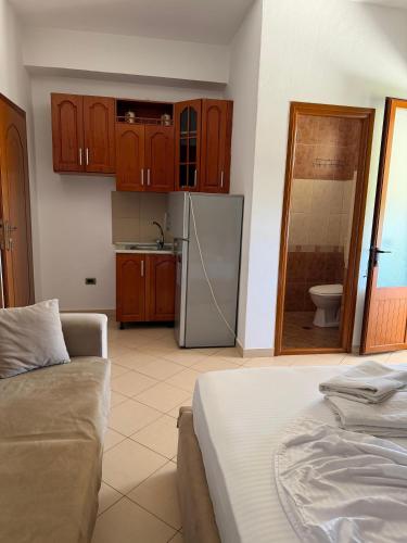 a kitchen with a couch and a refrigerator at Eid Mar in Vlorë