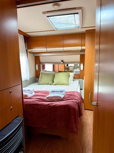 a small bedroom with a bed in the middle at Highway to Hel in Jastarnia
