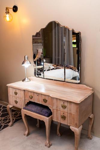 a dresser with a mirror on top of it at Big 5 Guest House Witbank in eMalahleni