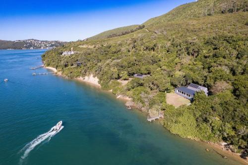 an island with a house and a boat in the water at The Glen Getaway in Lake Brenton