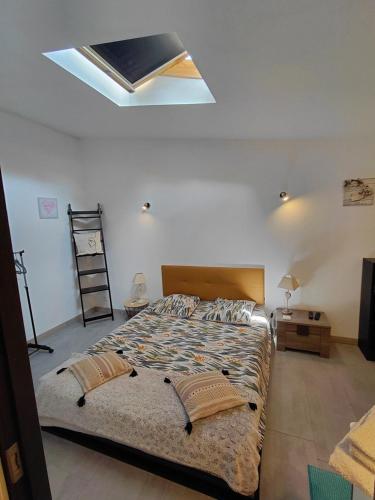 a bedroom with a bed and a skylight at Sous le soleil in Bandol