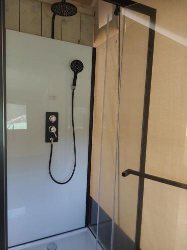 a shower in a bathroom with a shower head at casa la luna glamping in Alhaurín el Grande