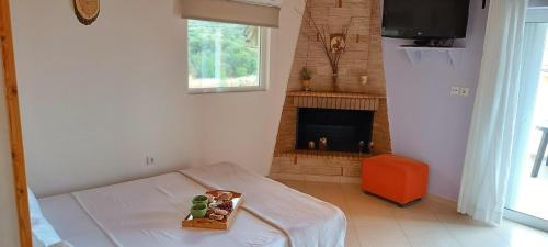 a white room with a fireplace and a tray of food at Local Paradise Xilokastro in Xylokastro