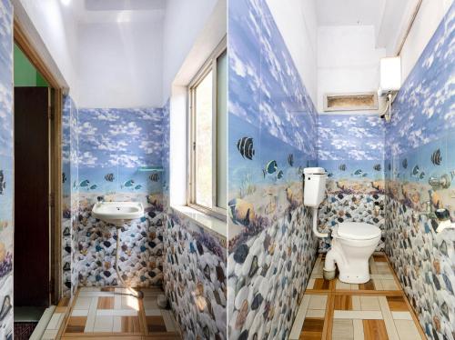 a bathroom with a toilet and a sink at Hotel Sridevi Grand in Vākalapūdi