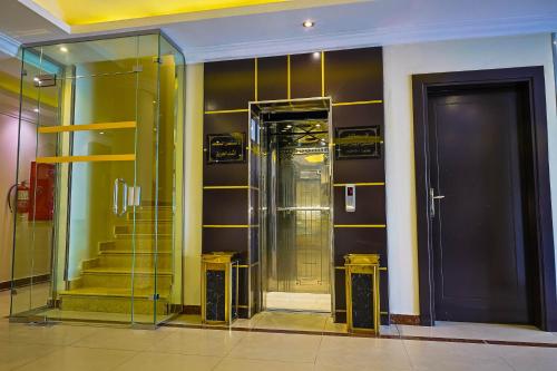 a elevator in a room with a door and stairs at Dar NEYAARA SERVICED APARTMENTS - Economic in Riyadh