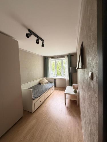 a bedroom with a bed and a window at Kauguri apartment residence in Jūrmala