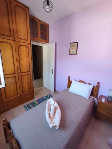 a dog laying on a bed in a bedroom at Kalymnos Sea View Villa in Kalymnos