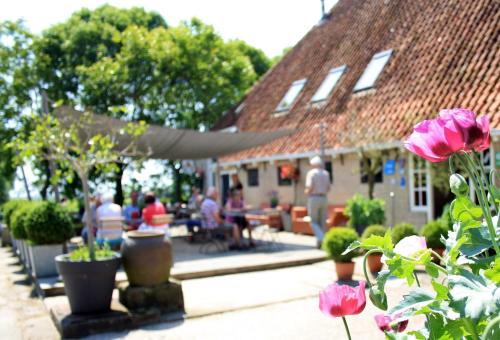 a group of people sitting outside of a building at Houseboats Pean-buiten Weidum in Weidum