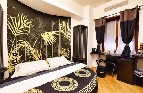a bedroom with a bed with a black and gold wall at IL Grattacielo Di Genova in Genoa