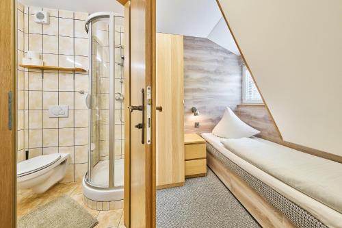 a bathroom with a shower and a toilet at Penzion Logla in Pec pod Sněžkou
