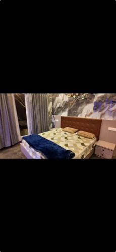 two pictures of a bedroom with a bed and boxes at La reve ecr , Panaiyur in Chennai