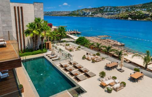 an aerial view of a resort with a pool and the ocean at Mare Deluxe Residences & Villas in Bodrum City