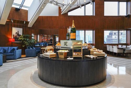 a large lobby with a bar with a bottle of wine at Radisson Collection Hyland Shanghai in Shanghai