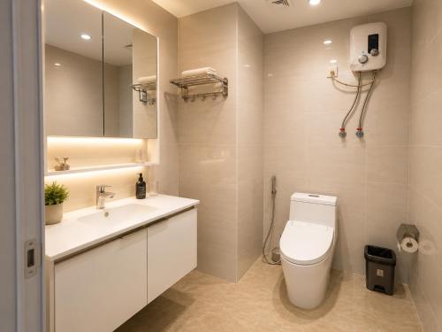 a bathroom with a toilet and a sink and a mirror at Tian Yue Hotel in Phnom Penh