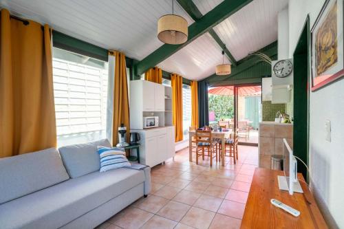 a living room with a couch and a kitchen at House with small garden and shared pool in Moliets-et-Maa